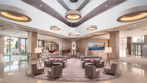 a lobby of a hotel with couches and chairs at Maistra Select Srebreno Villas in Mlini