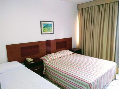 Кровать или кровати в номере Hotel Ipanema Inn Higienópolis