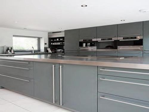 a large kitchen with stainless steel counters and stainless steel appliances at Warborough B&B in Wallingford