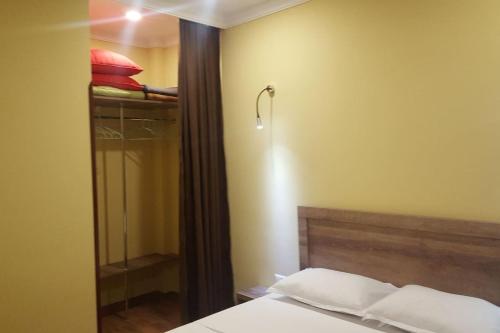 a bedroom with a bed and a walk in shower at Апартаменты у моря от Ирины in K'obulet'i