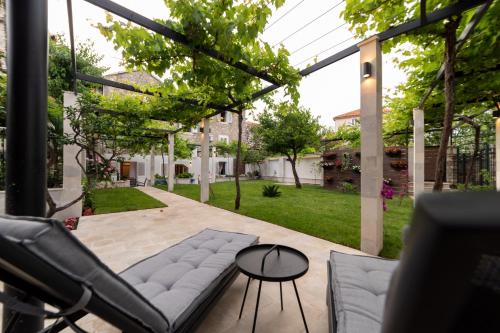 a patio with a couch and a table at Apartments Trifunovic Old Town in Budva