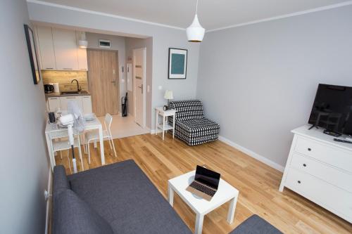 una sala de estar con un sofá y una mesa en CR Wygodny Apartament w Centrum Nowy Świat 13, en Białystok