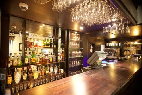 a bar with a counter with alcohol bottles at InnJoy Boutique Hotel in Centurion