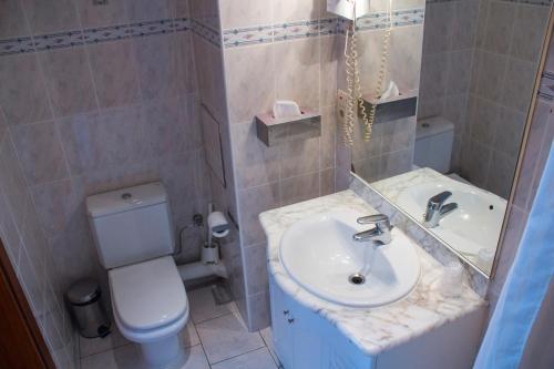 a bathroom with a sink and a toilet at Hotel Continental Gare du Midi in Brussels