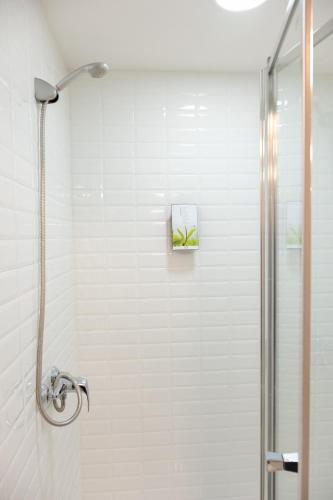 a shower with a glass door in a bathroom at Casas do Teatro in Porto