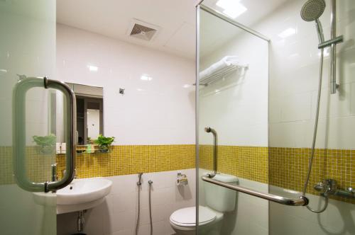 a bathroom with a toilet and a sink at Citin Hotel Masjid Jamek by Compass Hospitality in Kuala Lumpur