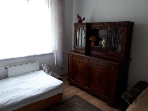 a bedroom with a bed and a wooden cabinet at Apartament u Barbary in Wisełka