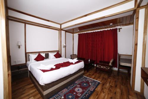 a bedroom with a bed and a red curtain at Buddha Retreat in Ravangla