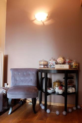 a table with a chair and a table with food on it at Gîte "L'échappée amoureuse et féérique" in Paliseul