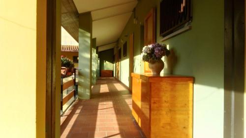 a hallway of a building with a vase of flowers at Casa con vista in Corniolo