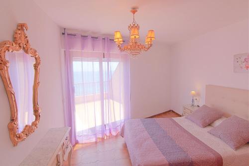 a bedroom with a bed and a mirror and a window at Caribe in Calpe