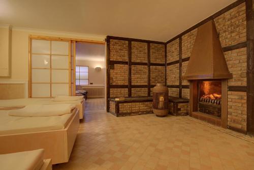 a room with a fireplace and a room with beds at Windeby 6D in Wenningstedt