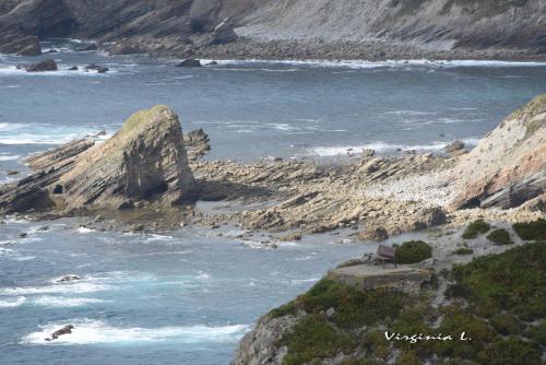 a view of the ocean from a bluff at Apartamentos rurales la Aguilera in Oviñana