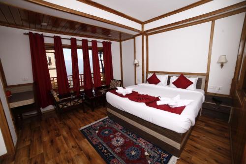 a bedroom with a large bed with red pillows at Buddha Retreat in Ravangla