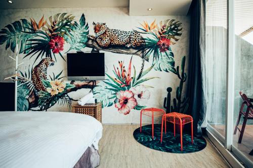 a bedroom with a mural of a leopard and a tv at 710 House in Eluan