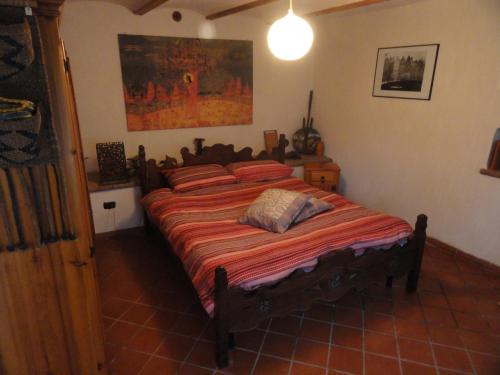 a bedroom with a large bed in a room at la casa sull'arcobaleno 1 in Manta