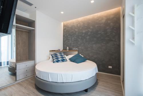 a bedroom with a large white bed in a room at Hotel Majorca in Gabicce Mare