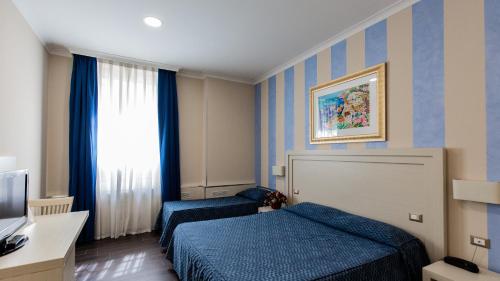 Hotel Palazzo Giancola tesisinde bir odada yatak veya yataklar