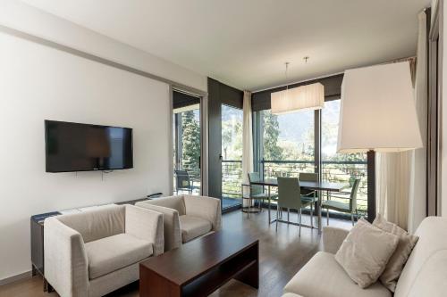 a living room with a couch and chairs and a table at Du Lac Et Du Parc Grand Resort in Riva del Garda