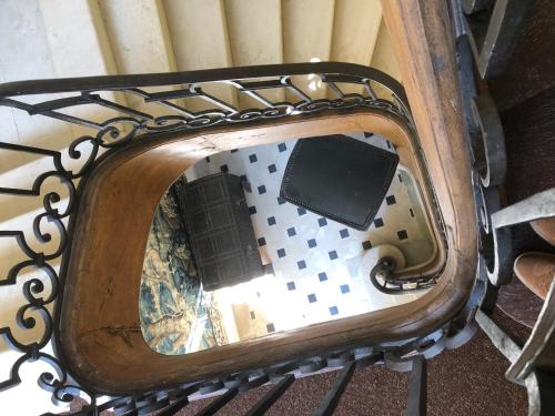 a mirror on top of a metal bench at Château de Villemorien in Villemorien