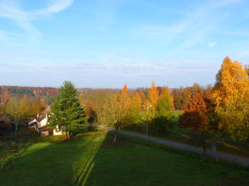 a house in the middle of a field with trees at Logis Hôtel Notre-Dame - restaurant ouvert midi et soir sauf dimanche soir in Danne-et-Quatre-Vents