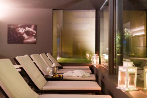 a room with chairs and a table and a picture at Du Lac Et Du Parc Grand Resort in Riva del Garda