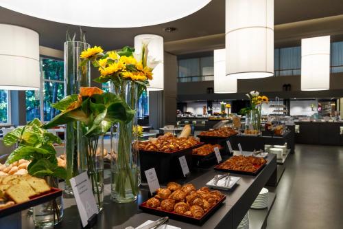 a buffet of pastries and other food items on display at Du Lac Et Du Parc Grand Resort in Riva del Garda