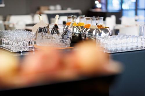 a table filled with glasses and bottles of wine at Du Lac Et Du Parc Grand Resort in Riva del Garda