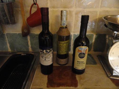 three bottles of wine sitting on a kitchen counter at la casa sull'arcobaleno 1 in Manta