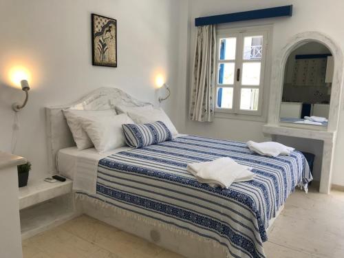 a bedroom with a bed with two towels on it at Dioskouri Art Villas in Kamari
