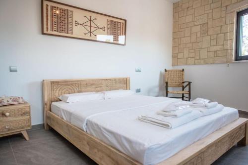 a bedroom with a large bed with a wooden frame at PanMari in Paphos City