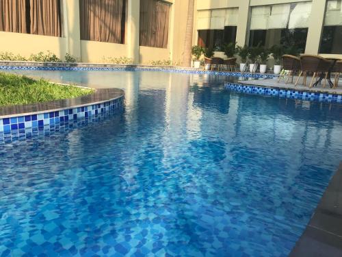 a large blue swimming pool in a building at NGAN HA HOTEL in Ðại Tiêt
