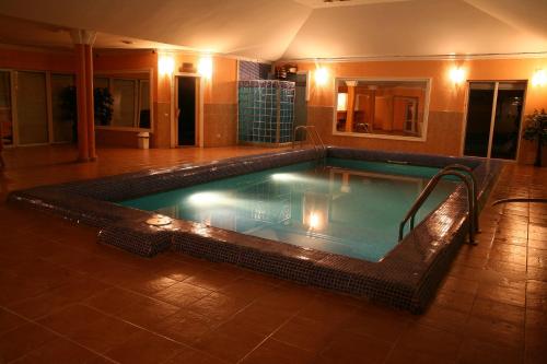 a large swimming pool in a hotel room at Hotel Continent in Polyana