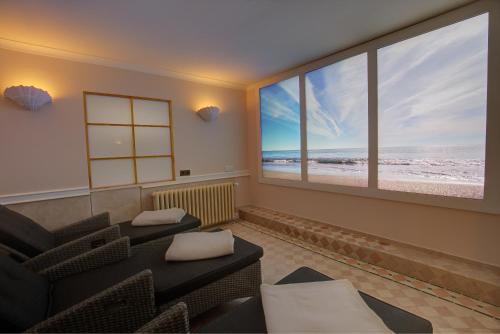 a living room with two couches and a view of the beach at Windeby 7T in Wenningstedt