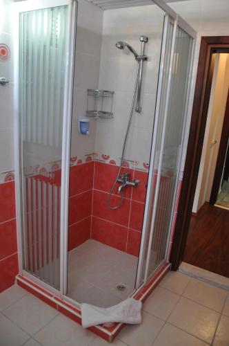 a shower with a glass door in a bathroom at Hotel Lunay in Antalya