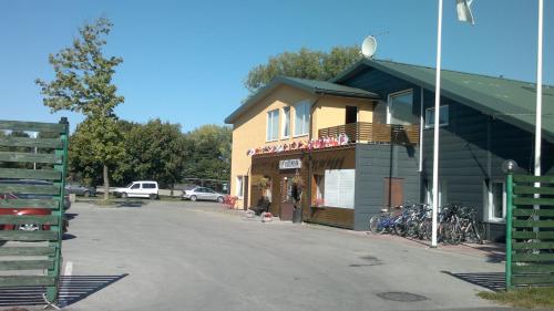 a building with bikes parked in a parking lot at Konse Motel and Caravan Camping in Pärnu