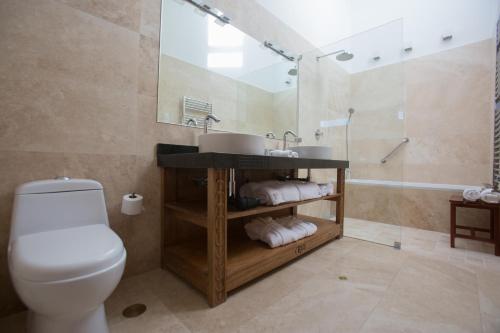 a bathroom with a toilet and a sink and a shower at Tocuyeros Boutique Hotel in Cusco