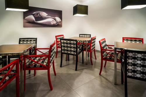 a dining room with red chairs and tables at Nautic Hotel & Spa in Can Pastilla