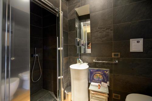 a bathroom with a shower and a sink and a toilet at Ranzoni 3 in Verbania