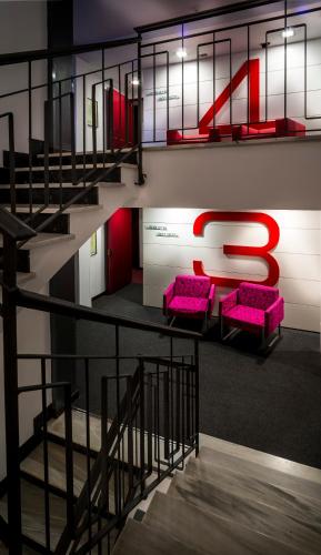 a staircase with purple chairs and a large letter s at Nautic Hotel & Spa in Can Pastilla