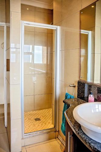 a bathroom with a shower and a sink at 9 Seesonnet Scottburgh in Scottburgh