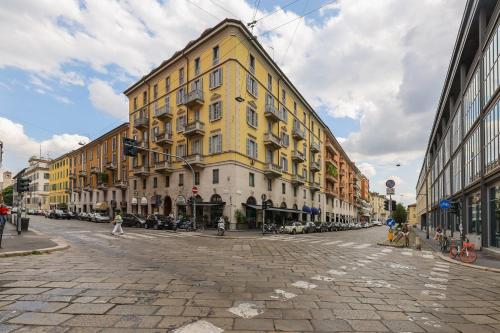 a large yellow building on a city street at Moscova Luxury B&B in Milan