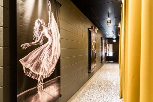 a hallway with a picture of a woman on a wall at Capitol Robinson by Bower Boutique Hotels in Moncton