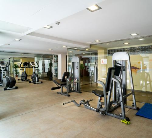 a gym with several treadmills and elliptical machines at Nautic Hotel & Spa in Can Pastilla