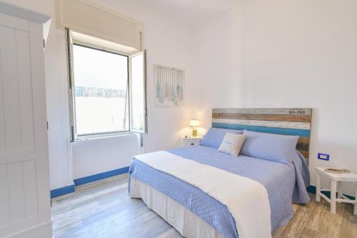 a bedroom with a large bed and a window at Rosanna Maison in Ischia