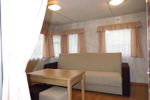 a living room with a couch and a table at Leśny Zakątek Radocza in Radocza
