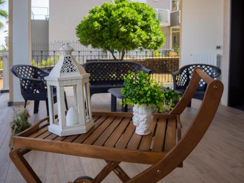 a table with a lantern and plants on a patio at Viaggio in Sicilia B&B in Gravina di Catania