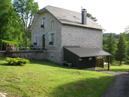 an old stone house with a gazebo in the yard at La maison in Tarnac