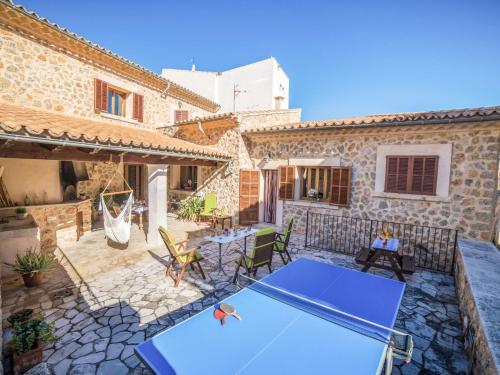 a house with a ping pong table on a patio at Holiday Home Son Trobat by Interhome in Mancor del Valle