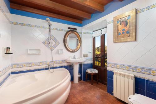 a bathroom with a tub and a sink at Casa de Aldea con Piscina Calefactada opcional - CA-1451-AS in Villaviciosa